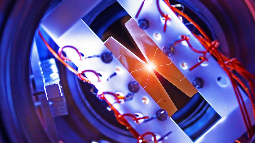 An ion trap with four segmented blade electrodes used to trap a linear chain of atomic ions for quantum information processing