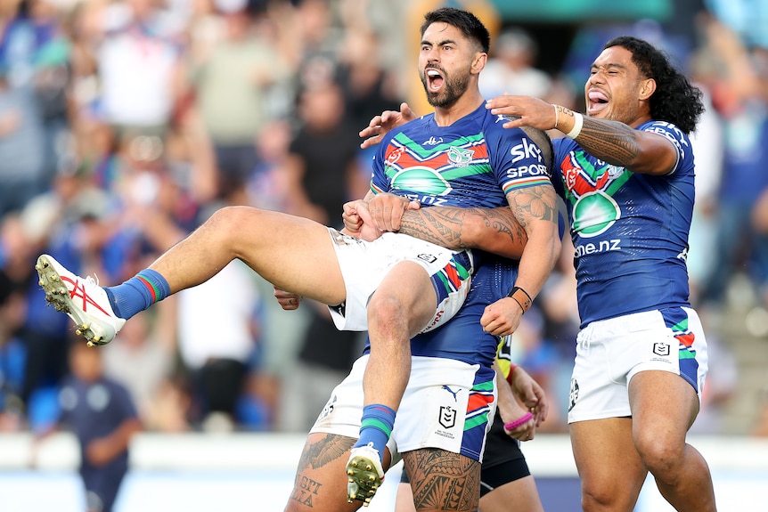 Three Warriors NRL players celebrate a try against Canterbury.