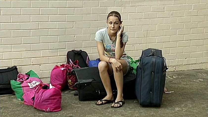 14-year-old Rachel Pazos sits outside the unit she shared with her father