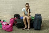 14-year-old Rachel Pazos sits outside the unit she shared with her father