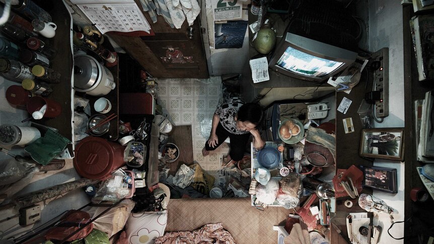 Woman in tiny flat in Hong Kong.