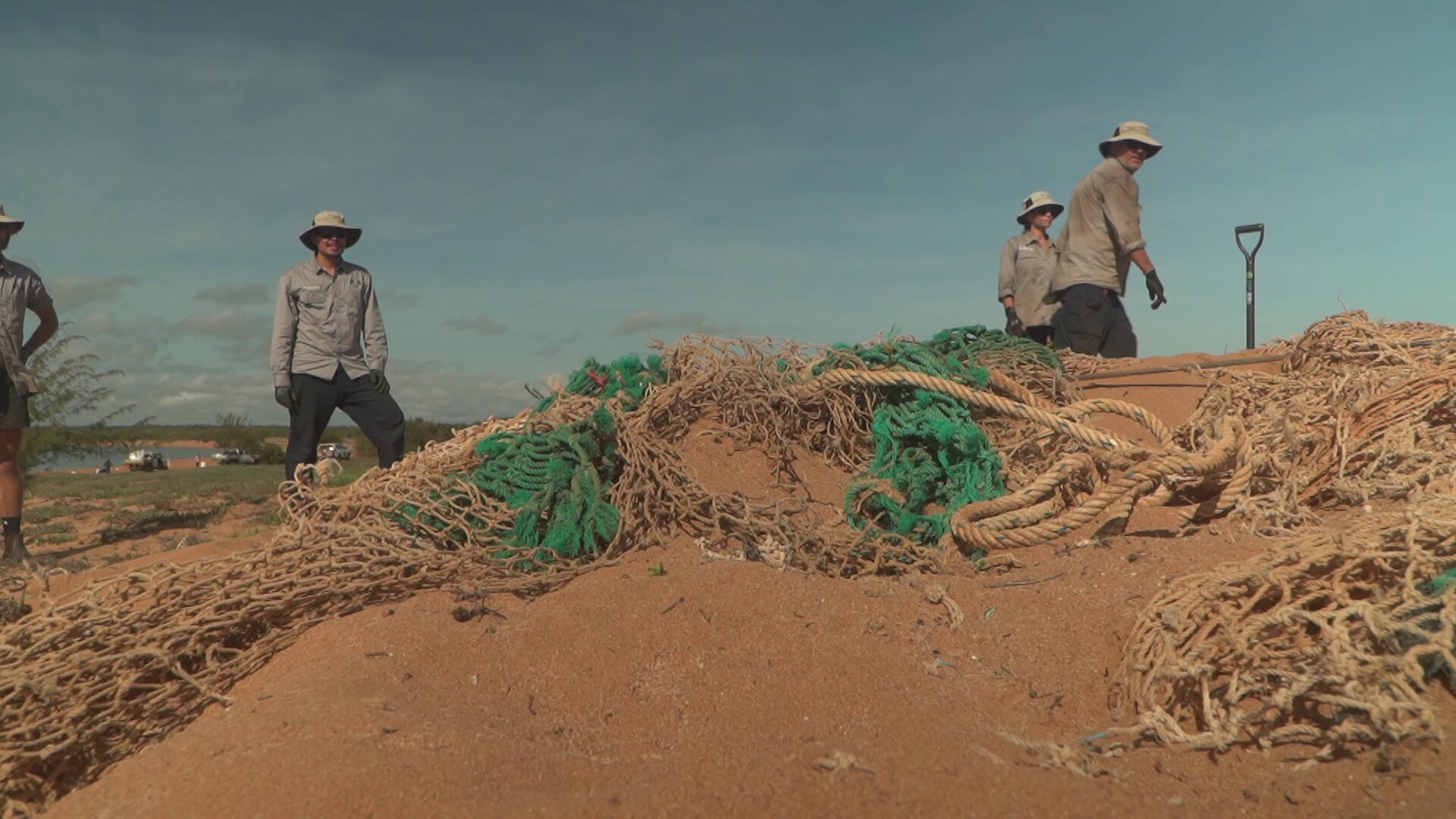Fishing nets being winched out of the sand. - ABC News