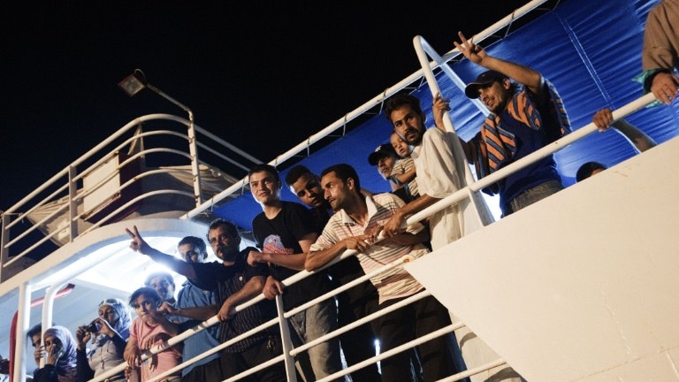 Political prisoners from Abu Salim prison cheer as they arrive in Benghazi's main harbour.