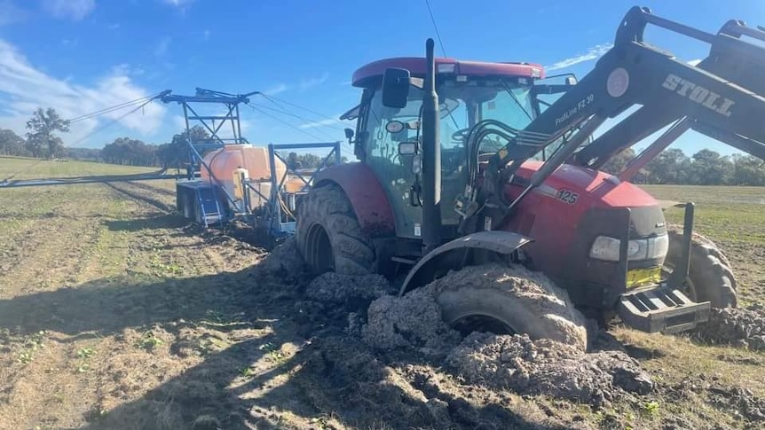 a tractor bogged in a paddock