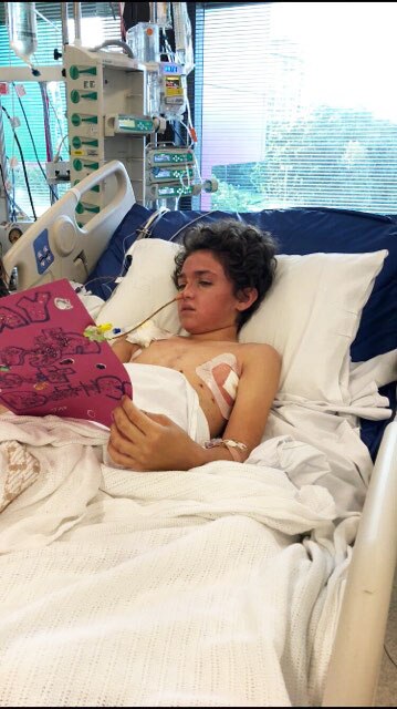 Connor Creagh in a hospital bed at the Queensland Children's Hospital after being crushed by a tree in October 2018.