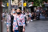 People wearing masks in a queue