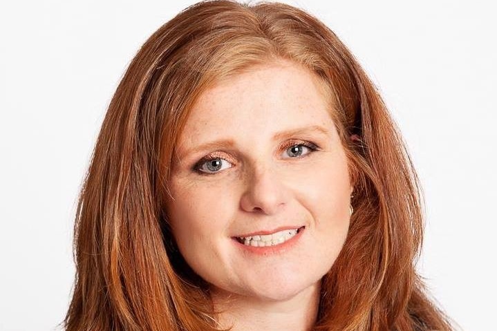 Portrait of a female with red hair, looking at the camera