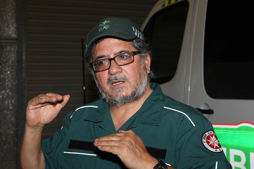 A West Australian St John Ambulance volunteer explaining with his hands