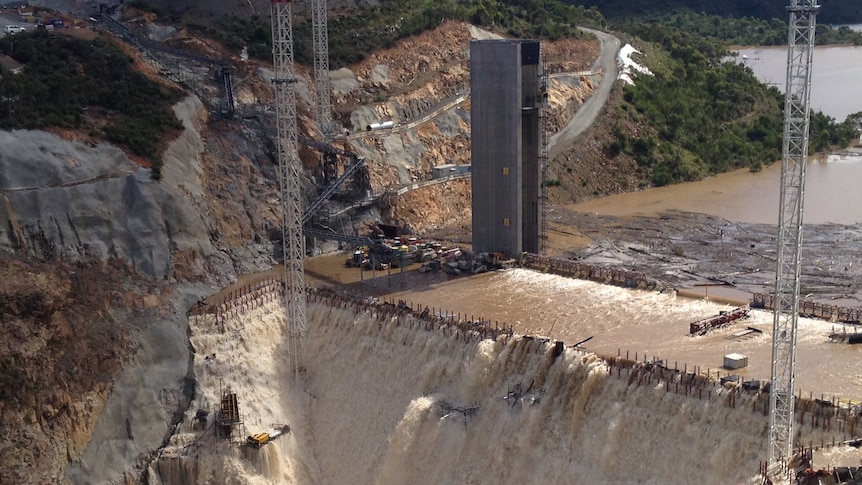 Further delays: floodwaters spilled over the new Cotter Dam wall in March.