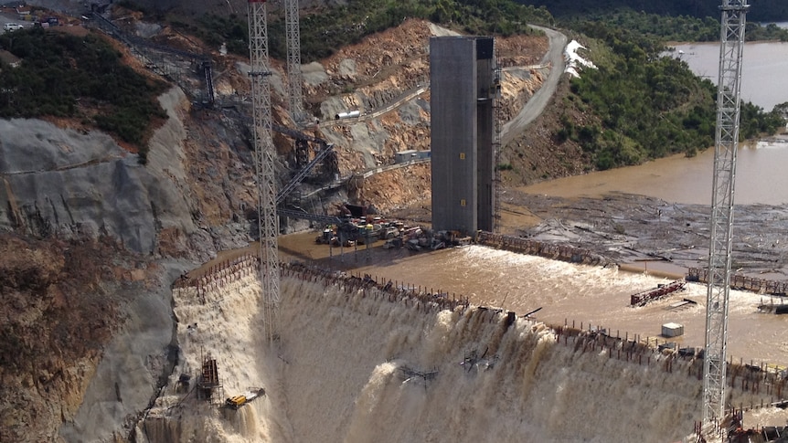 Floodwater and debris spilling over the Cotter Dam wall in March.