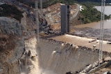 Further delays: floodwaters spilled over the new Cotter Dam wall in March.