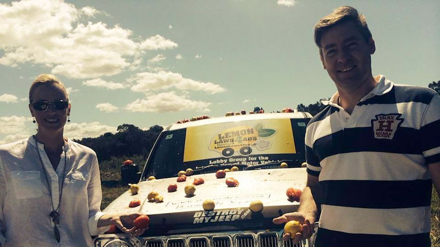 Two friends stand beside Ashton Wood's faulty Jeep