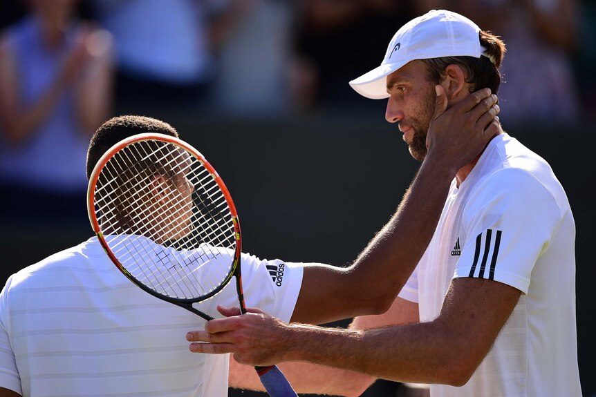 Ivo Karlovic is congratulated on his victory by Jo-Wilfried Tsonga
