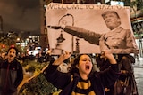 An anti-Trump protester holds a 'Welcome to Nazi, USA' sign as she marches through Manhattan.