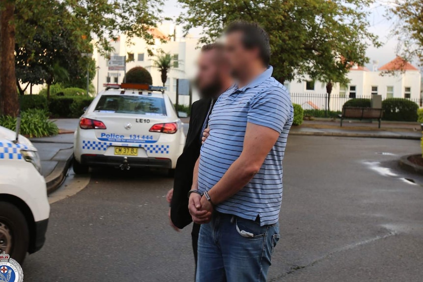 Police officers arrest a man