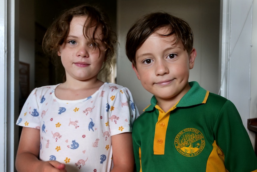 two young kids look into the camera