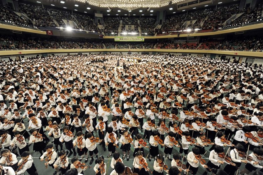 Hundreds of children play the violin as part of the graduation ceremony in Tokyo