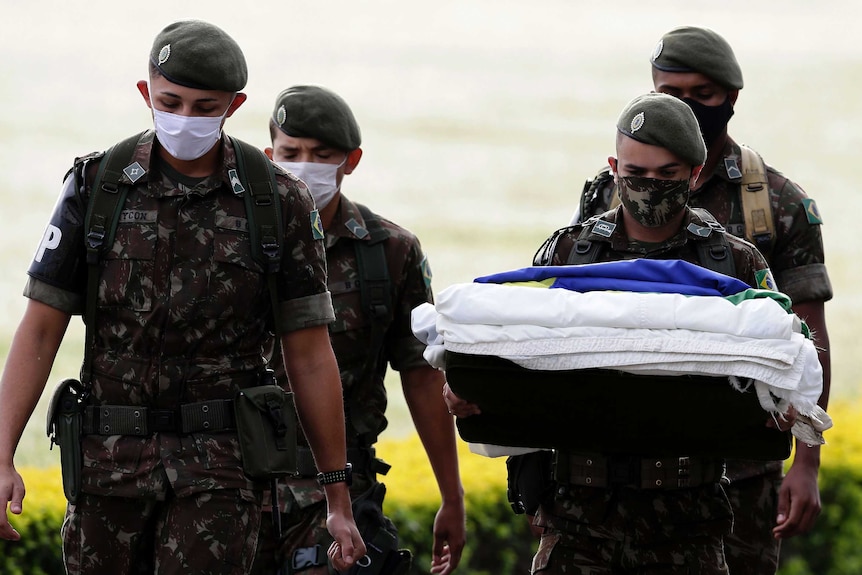 Presidential guards wear face masks during a flag-hanging ceremony