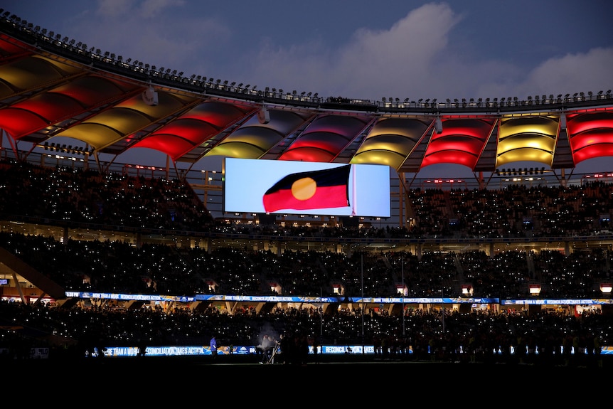 The Aboriginal flag on the screen at Optus Stadium in Perth before the AFL game between West Coast and Essendon.