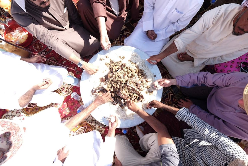 Empty quarter: locals share food with the Empty Quarter expedition in Oman