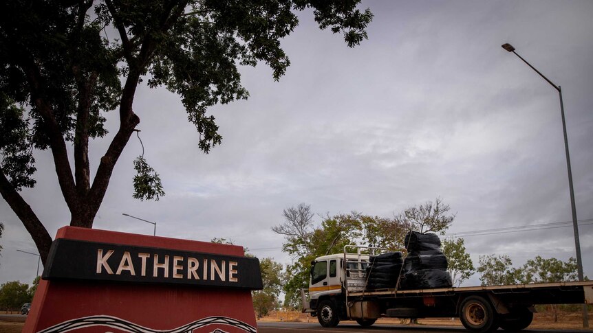 A Katherine sign and a truck under dark clouds