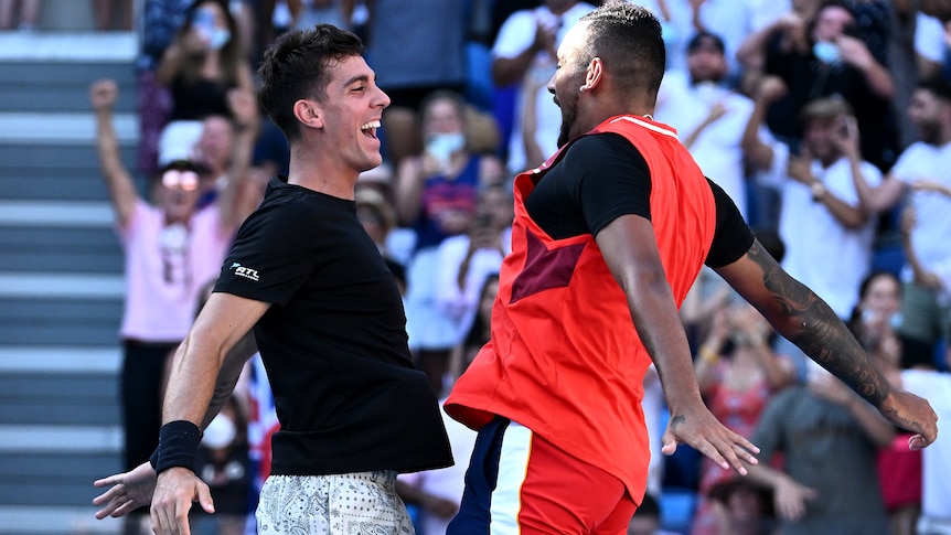 Thanasi Kokkinakis and Nick Kyrgios engage in a chest bump celebration.