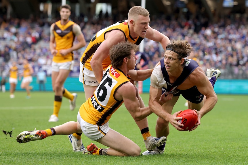 Nat Fyfe being tackled 