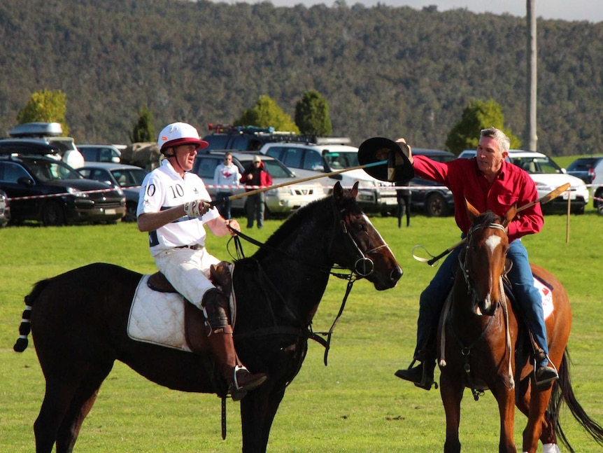 Dave Olsen gets his hat back during polo match