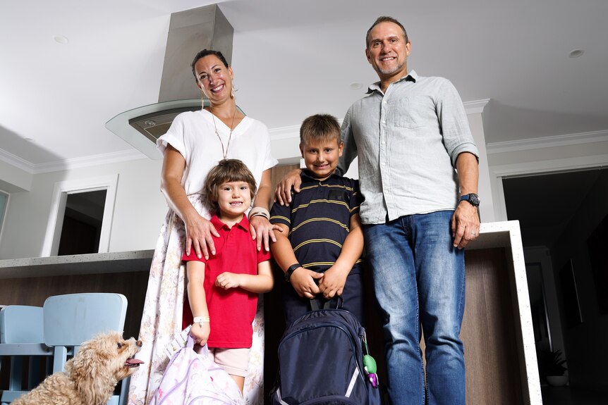 Dinah Thomasset, Maeva (4), Noah (6) and Shane Hearn standing in their Adelaide home kitchen