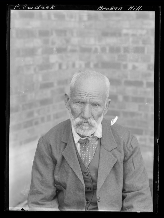 Black and white photograph of an older Indian man in a suit