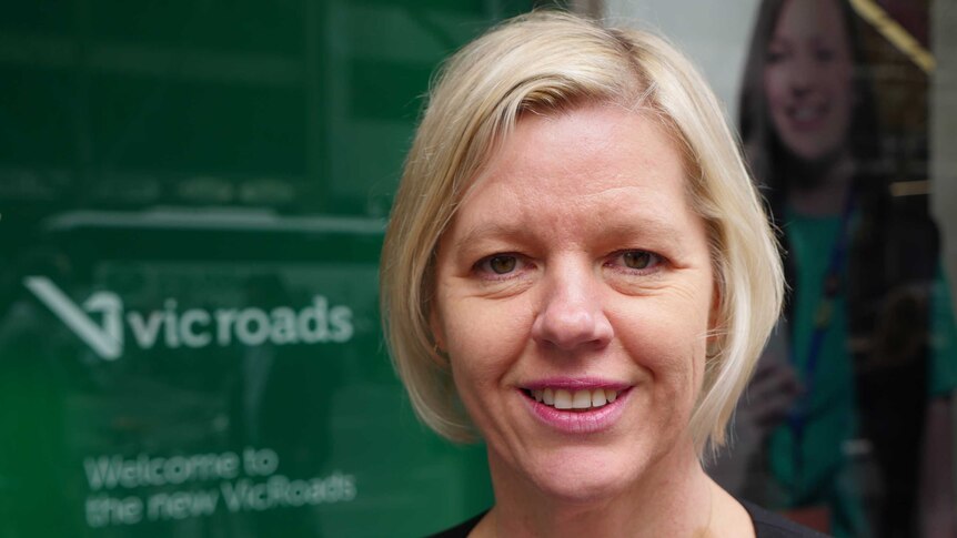VCOSS CEO Emma King stands in front of a VicRoads office