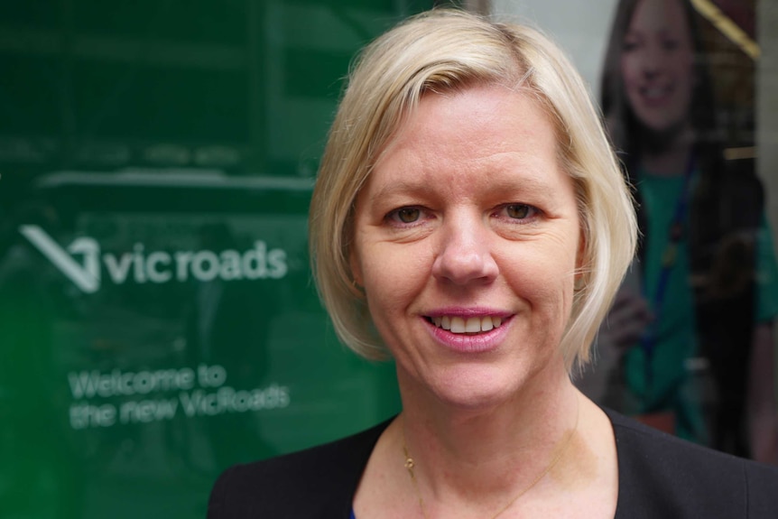 VCOSS CEO Emma King stands in front of a VicRoads office