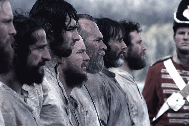 Convicts in a line up as depicted in a movie.