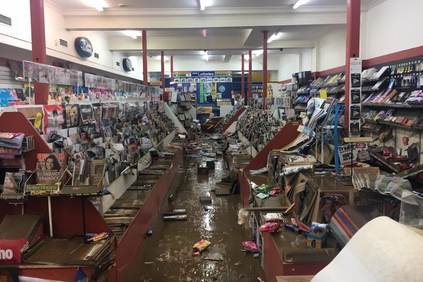 The Lismore newsagency after floodwaters receded - magazines, newspapers and stationery were strewn across the muddy floor
