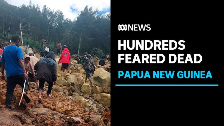 Hundreds feared dead, Papua New Guinea: A group of people with their backs to camera clamour over rocks and rubble. 