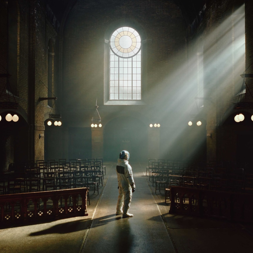 Photograph of an astronaut standing inside a church
