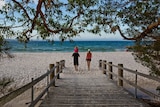 A boardwalk extends onto a beach.