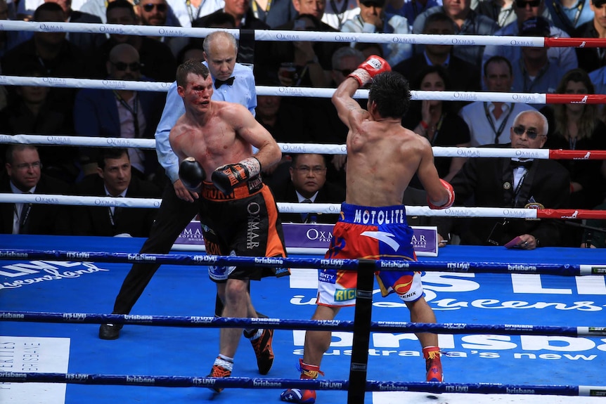 A battered Jeff Horn sways away from Manny Pacquiao