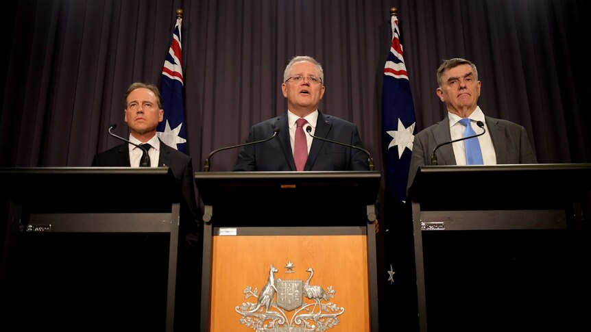 Picture of Australian PM, Health Minister and CMO at podium