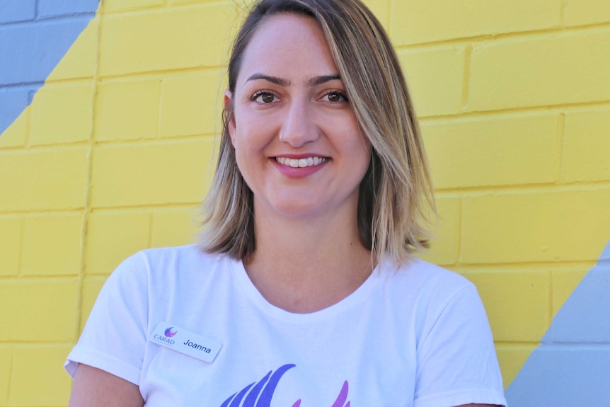 A head and shoulders shot of a smiling CARAD general manager Joanna Josephs posing for a photo in front of a brick wall.