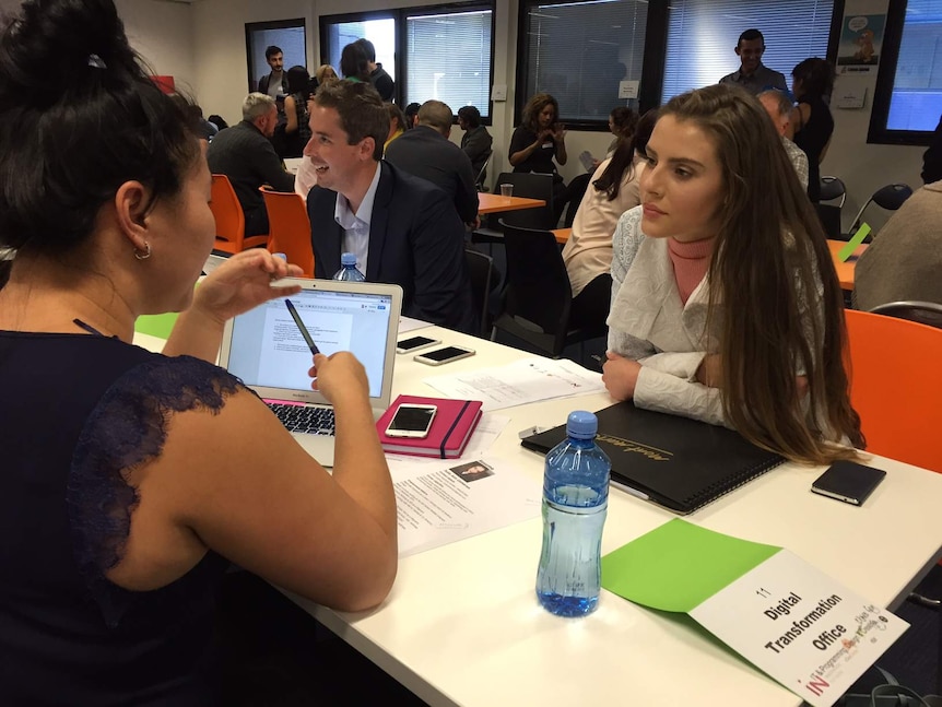 Canberra student Julia Cameron sits at a table for the speed-dating-style event.