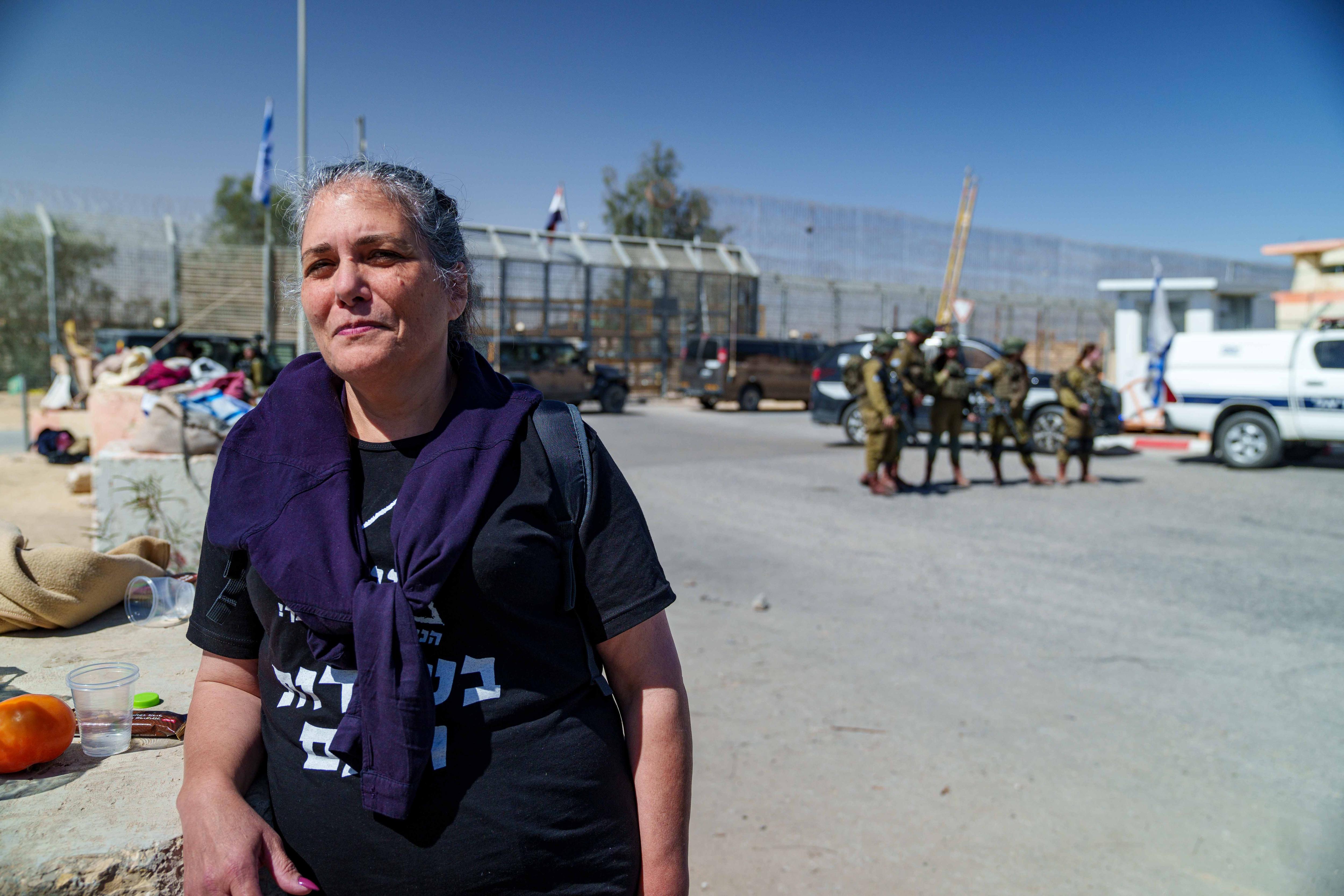 A woman standing at a fence