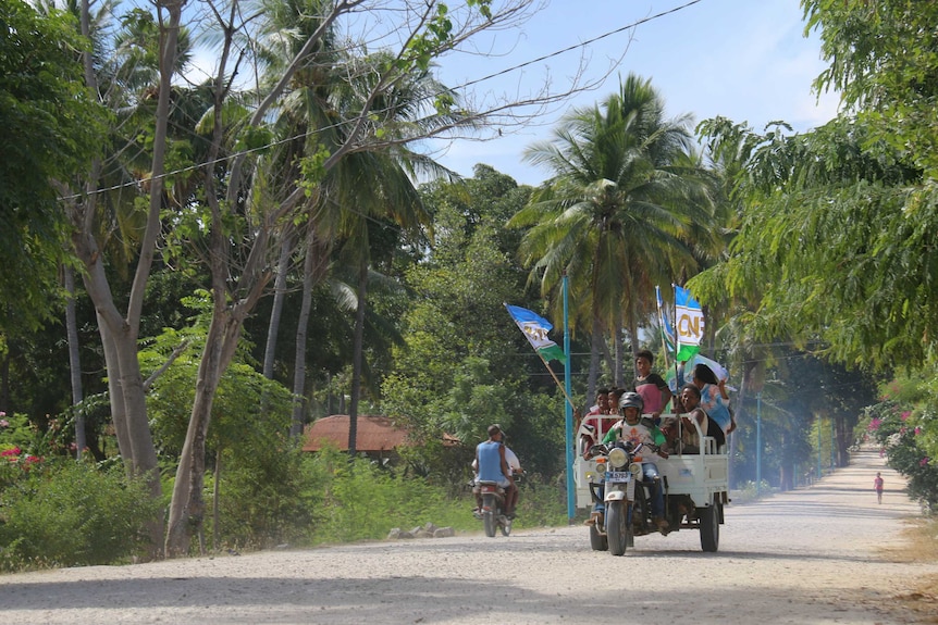 An election campaign truck drives down a dirt road in Atauro.