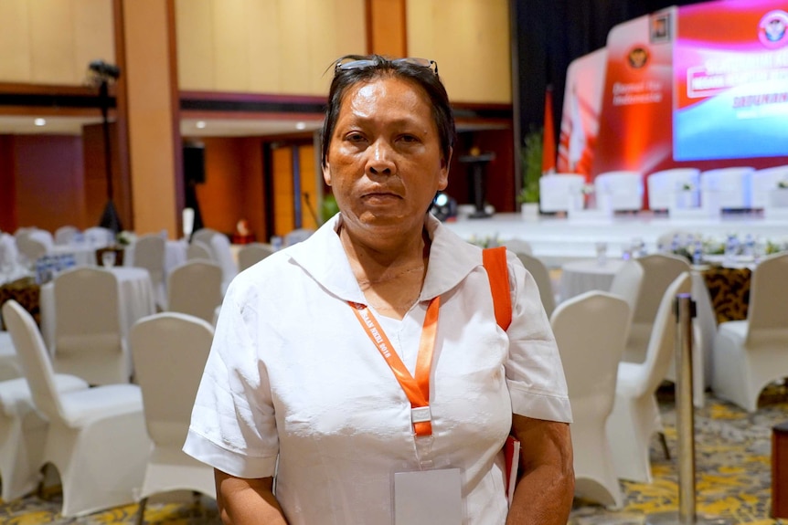 Woman stands in front of tables