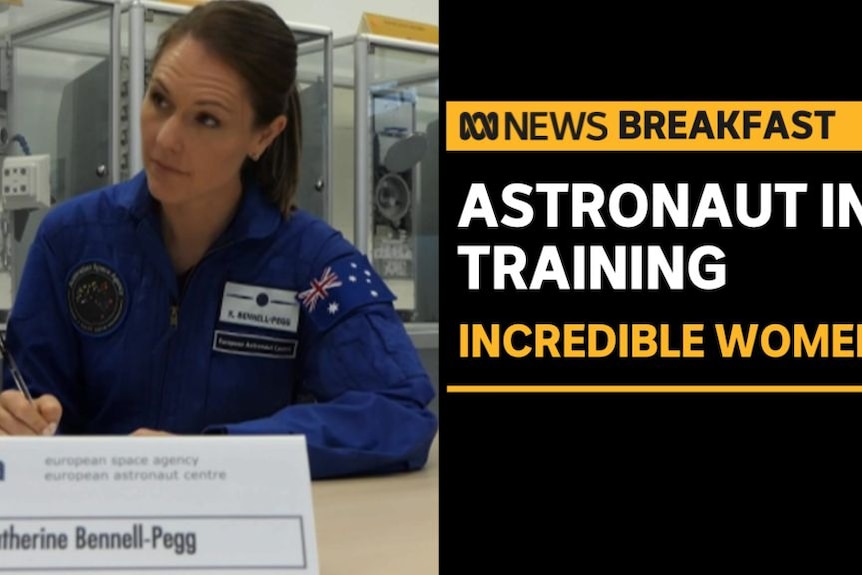 Astronaut in Training, Incredible Women: A woman in a blue flightsuit with an Australian flag patch on her sleeve holds a pen.