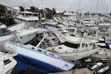Damaged boats are stacked on top of one another at Port Hinchinbrook boat harbour in Cardwell.