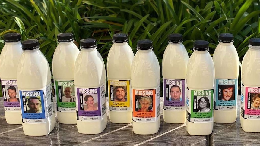 Sixteen bottles of Canberra Milk promote the faces of missing Australians.