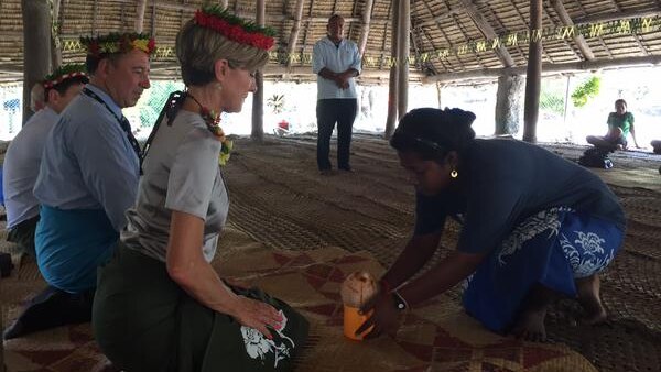 Australia's foreign minister taking part in a traditional welcome in Kiribati