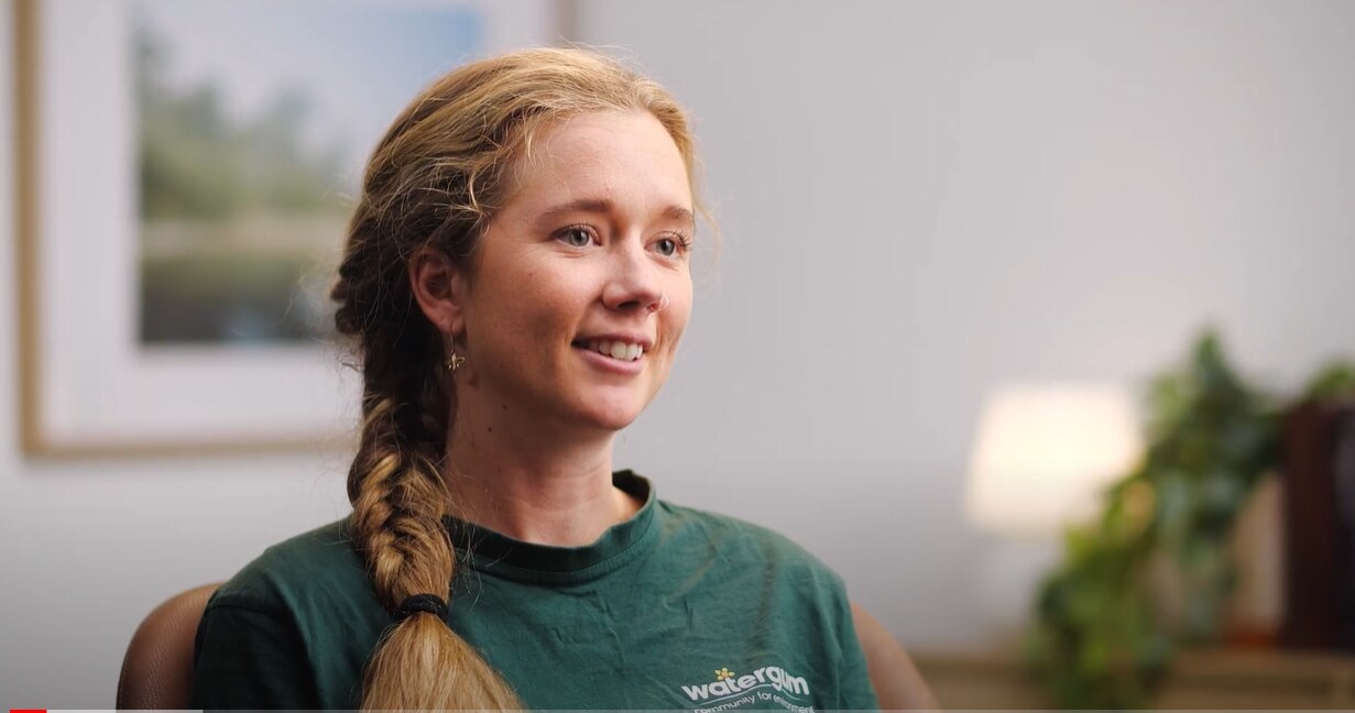 A young woman in a white room