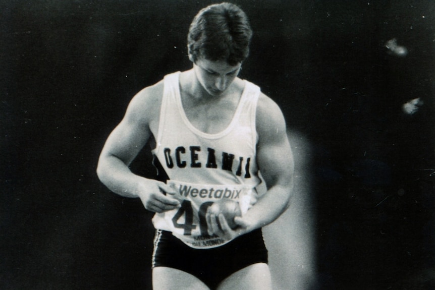 Bev as a young woman, about to throw a shot put.